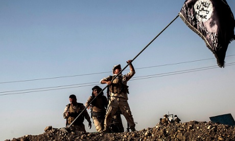 Kurdish border police take down an Isis flag after taking control of Yangija village in September last year