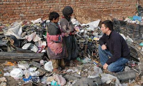 Marc Koska talks to two children at rubbish dump