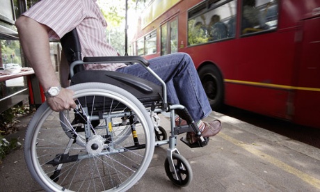 Disabled man in wheelchair at bus stop