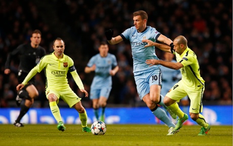 Edin Dzeko holds off Javier Mascherano.
