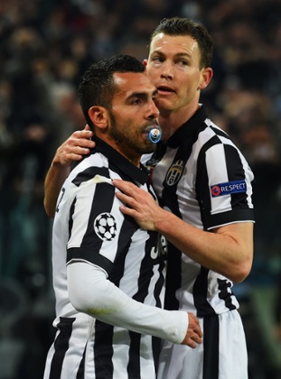 Carlos Tevez celebrates with Stephan Lichtsteiner.