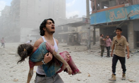 A man carries a girl injured in a reported barrel-bomb attack in Kallaseh district, Aleppo, last year.
