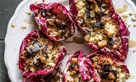 A radicchio leaf with pesto di noce, bulgur wheat, fried aubergine and some tahini on top