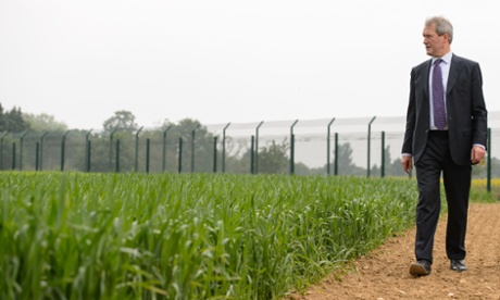 Former UK environment secretary Owen Paterson views a genetically modified crop trial during a visit to Rothamsted Research, Hertfordshire.