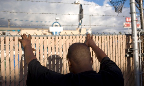 A man suspected of being a gang member is searched by LAPD officers.
