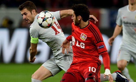 Atletico Madrid's Gabi and Leverkusen's midfielder Hakan Calhanoglu vie for the ball.