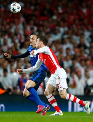 Dimitar Berbatov beats Laurent Koscielny to the ball.