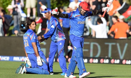 Afghanistan batsman Hamid Hassan (R) celebrates with Shapoor Zadran (L) and reserve Usman Ghani (C) after the dramatic finale in Dunedin.