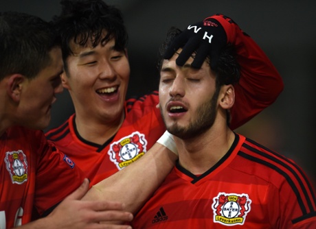 Leverkusen's midfielder Hakan Calhanoglu and his teammates celebrate after scoring.
