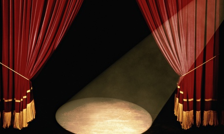 Theatre curtains and spotlight on an empty stage