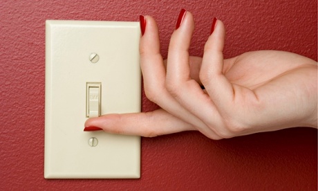 woman switching light switch