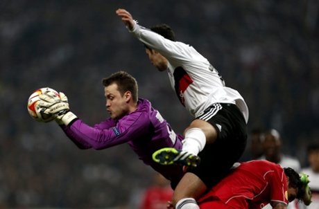 Simon Mignolet takes the ball ahead of Besiktas' Serdar Kurtulus.