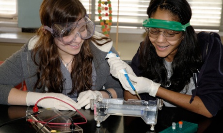 Girls carry out an experiment in a biology class. While there is an even gender split in biological sciences, only 14% of engineering graduates are women.