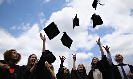 Students from the University of the Arts London throw their caps in the air ahead of their graduatio