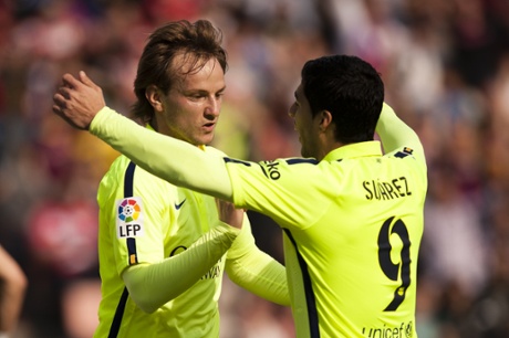 Barcelona's Ivan Rakitic celebrates his goal with  Luis Suarez at Los Carmenes stadium in Granada.