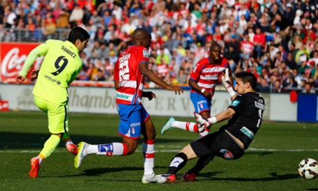 After his double against Man City, Luis Suarez scores past Granada's goalkeeper Oier Olazabal.