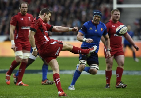 Wales' fly-half Dan Biggar launches the ball upfield.