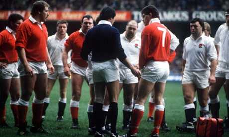Referee Ray Megson talks to the players in an attempt to calm down the trouble.