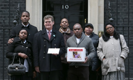 Supporters of the Gada family, including local MP Stephen Lloyd (third from left), hand in a petition at 10 Downing Street on 27 January.