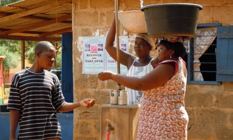 Women paying for water in Ghana