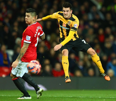 Ryan Donaldson shows Cambridge's fighting spirit as he let's fly past United goalscorer Marcos Rojo.