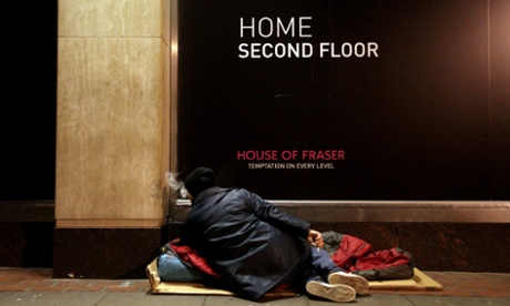 A homeless man rests outside a London department store. The capital has the worst homelessness in England, the report says.