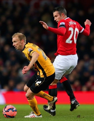 Cambridge United's Luke Chadwick breaks away from an ineffective Robin van Persie.