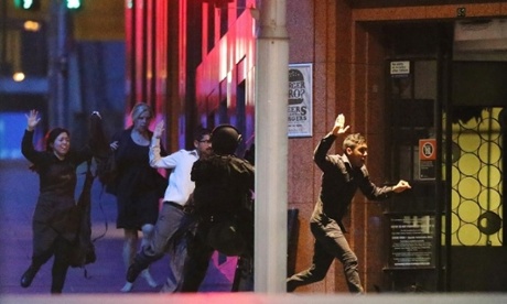 People run with their hands up from the Lindt Cafe. Photograph: Joosep Martinson/Getty Images