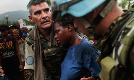 UN peacekeepers look after a pregnant woman after the Haiti earthquake in 2010.