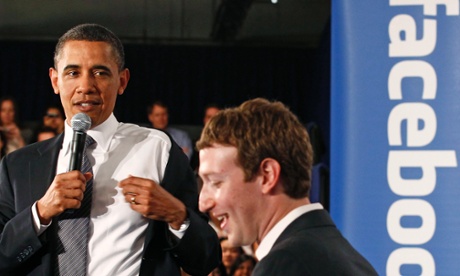 Barack Obama takes off his jacket as he attends a town hall meeting at Facebook headquarters with CEO Mark Zuckerberg in Palo Alto, April 20, 2011.