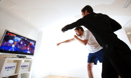 Two men using Xbox Kinect.