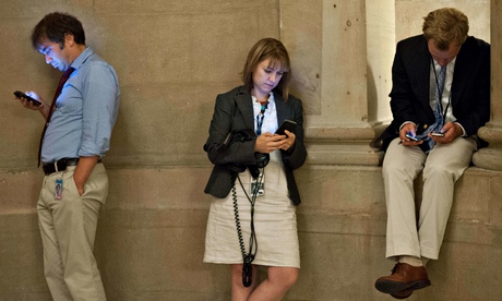 People checking their smartphones