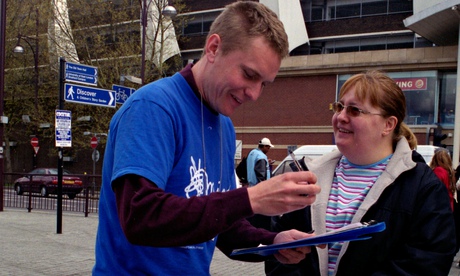 A fundraiser in the street with a woman shopper