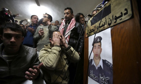 A man prays for the soul of the captured Jordanian pilot, after hearing the news of his execution by Isis.