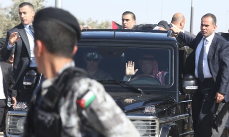 King Abdullah  arrives as Jordanians stand along the way between Amman and Queen Alia airport waiting to greet him.