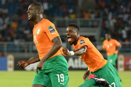 Yaya Toure celebrates with Serge Aurier (R) after scoring.