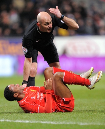 Raheem Sterling picks up a knock.