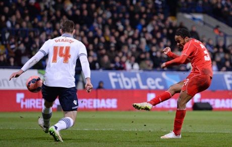 Raheem Sterling takes a shot, but hits the Bolton post.