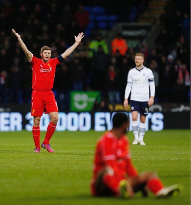 Steven Gerrard appeals for a foul after Raheem Sterling clashed with with Dorian Dervite.