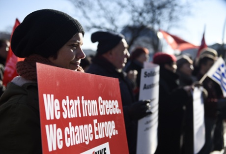 A protestor holds a sign reading 