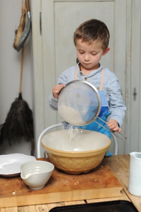 Child's play: sifting in the flour to make the dumplings.