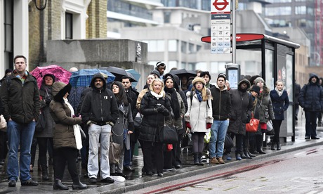 Commuters wait in hope for a bus in London