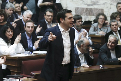 Greece's Prime Minister Alexis Tsipras and leader of the Syriza left-wing party arrives to speak to his party members of parliament in Athens, Thursday, Feb. 5, 2015.