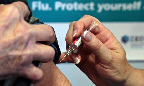 Patient is injected into upper arm with flu vaccine