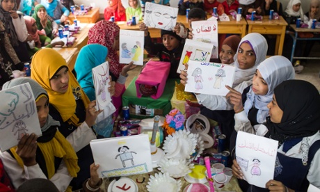 Children holding up anti-FGM pictures they drew at a school in Assiut, Egypt, on 1 February.