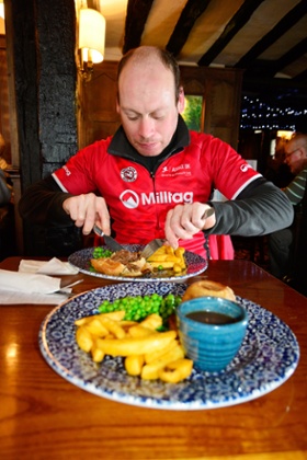 Abraham tucks into a steak and kidney pie, chips and peas at a pub in Tewkesbury,  Gloucestershire.