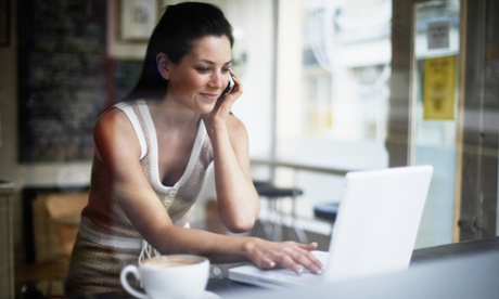 Young woman using mobile phone and laptop