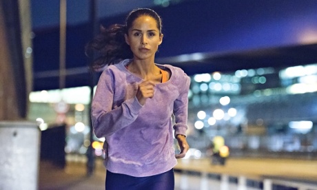 Female athlete run through the city at night