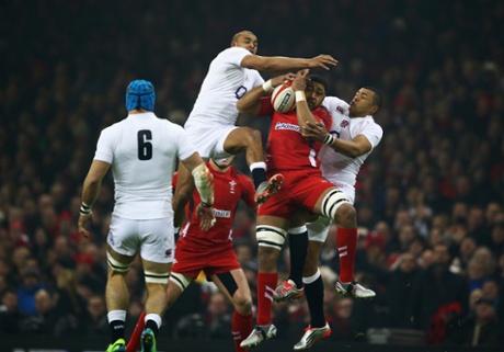 Toby Faletau of Wales catches the ball with Jonathan Joseph and Luther Burrell of England competing.