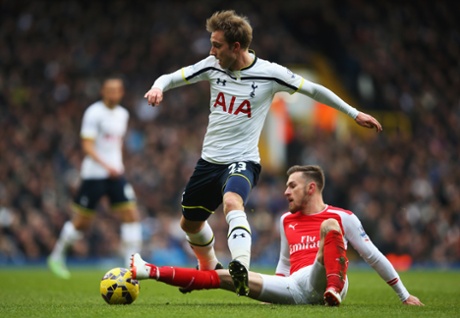 Aaron Ramsey stops the charge of Christian Eriksen.